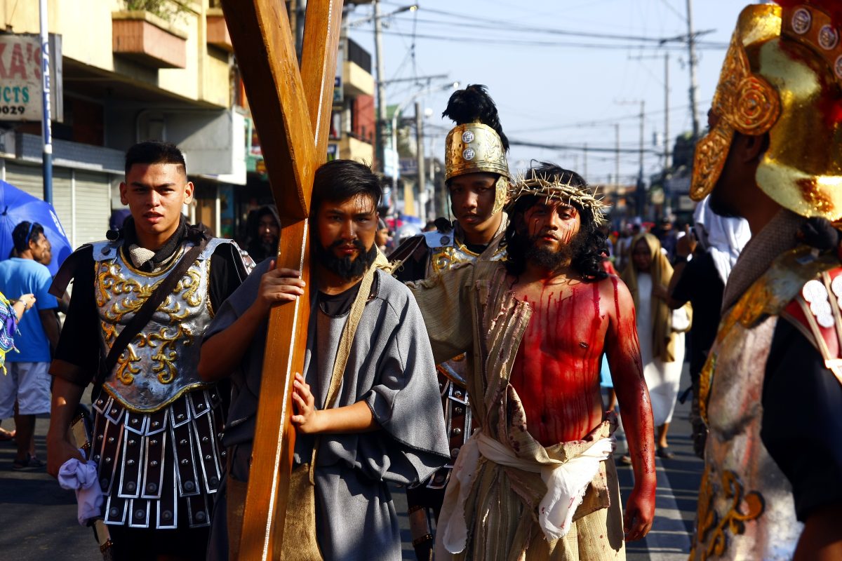Catholic devotees in the Philippines wear costumes and re-enact the Passion of Jesus Christ on Good Friday during Holy Week. 