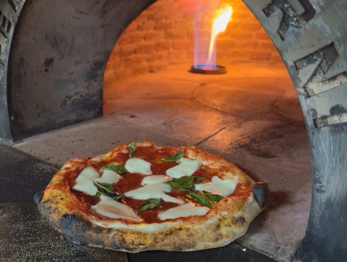 Pizza entering oven 