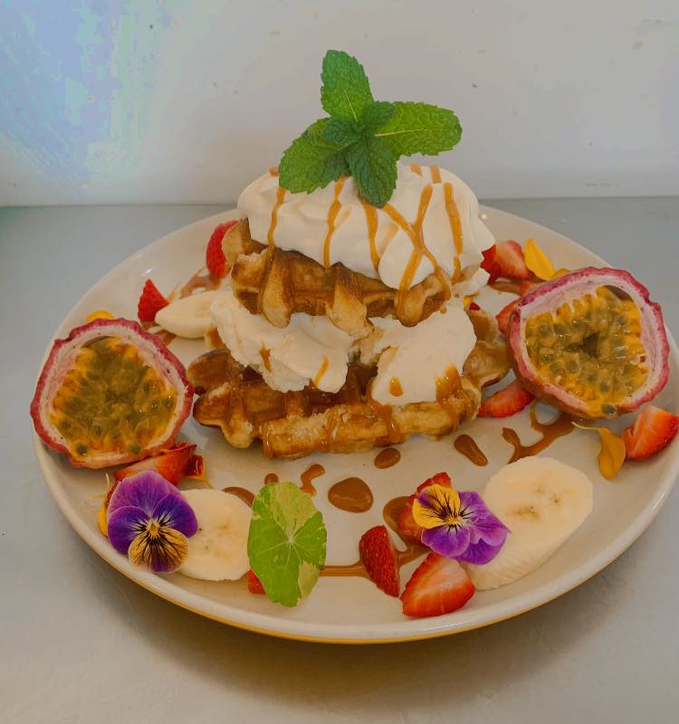 Delicious waffles with ice cream, passionfruit, strawberry and banana. 