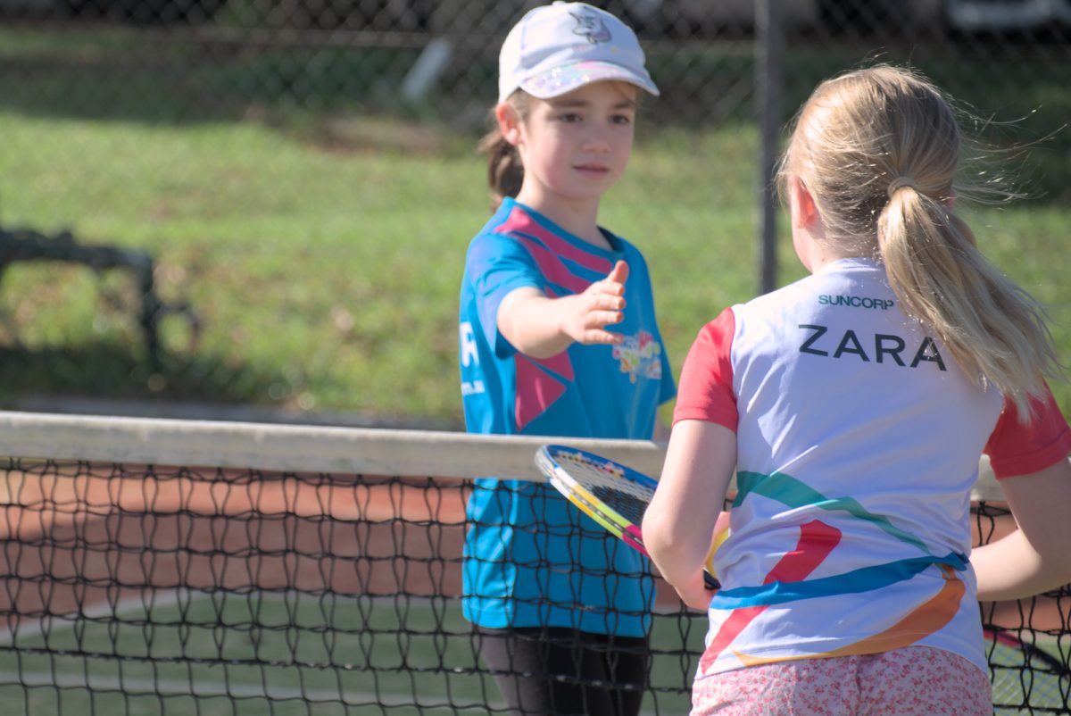 Two girls playing tennis