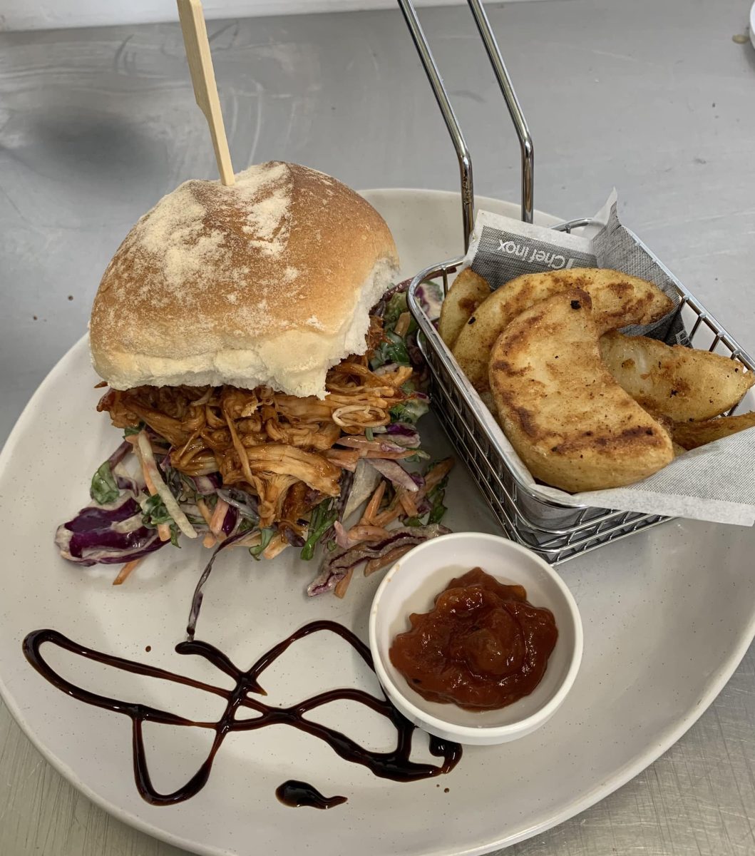 Slow cooked shredded chicken, coleslaw on a damper bun with a side of wedges