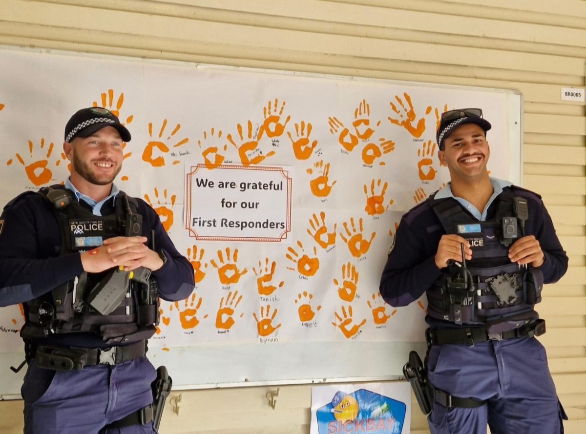 Griffith police in front of finger painting