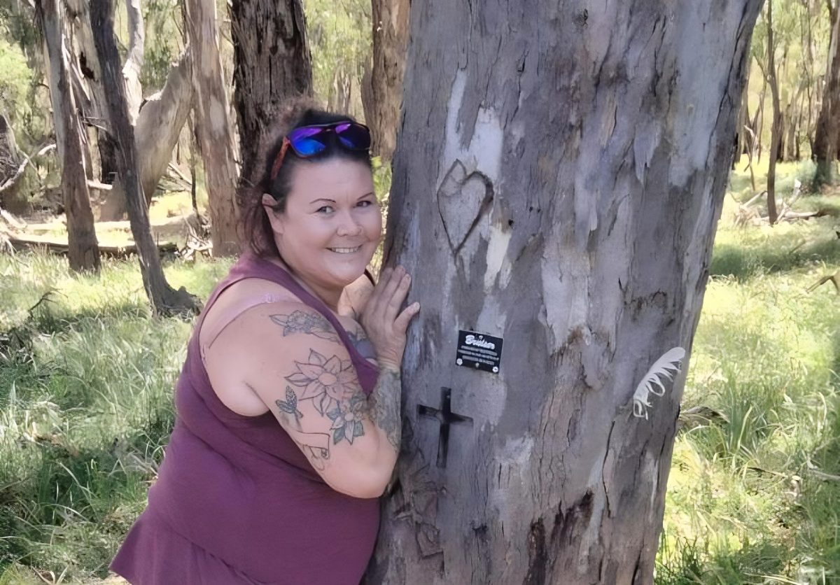 Rachel Merrett hugging a tree 