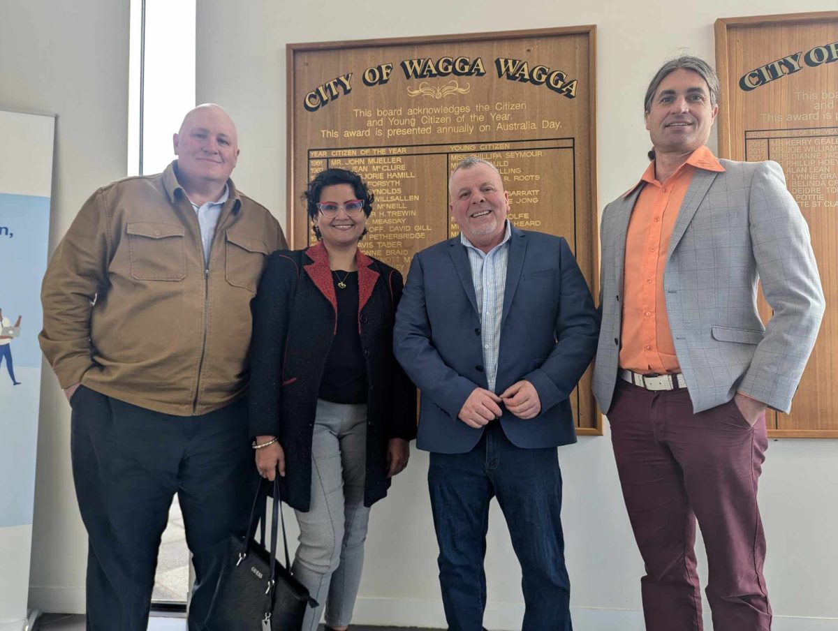 four people standing together at city council offices