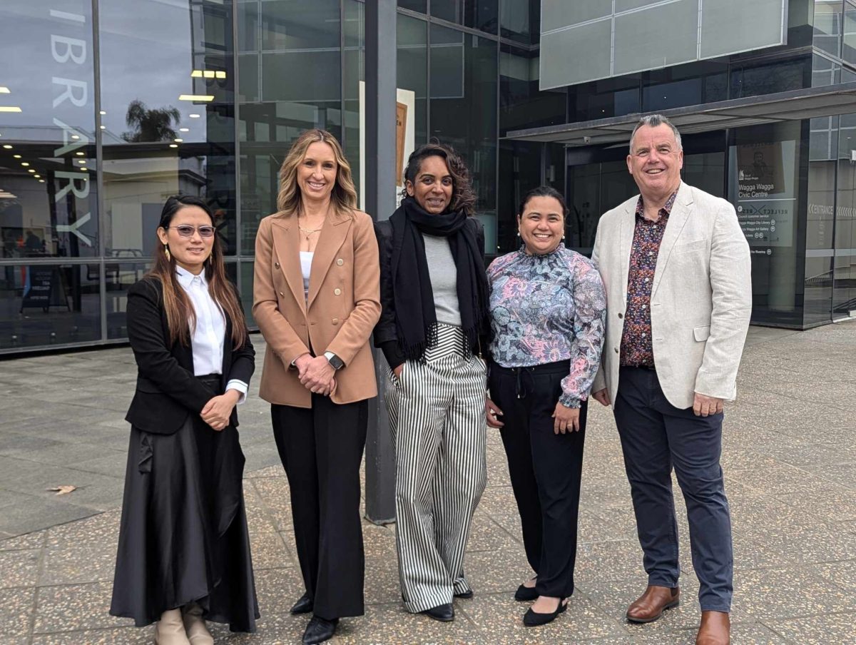 A group of people standing outside a council library