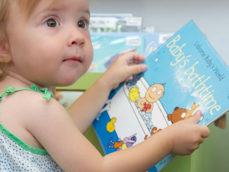 child holding a book