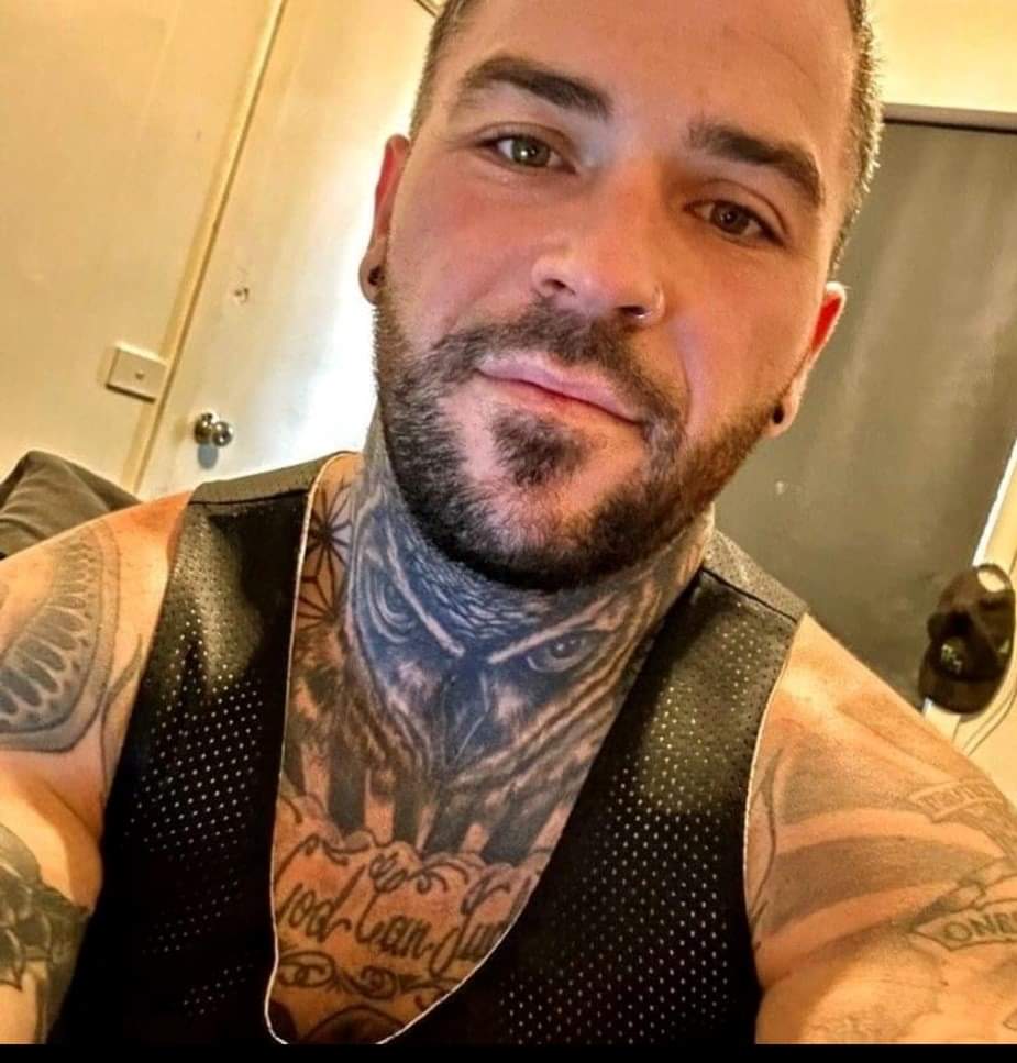 heavily tattooed man in selfie