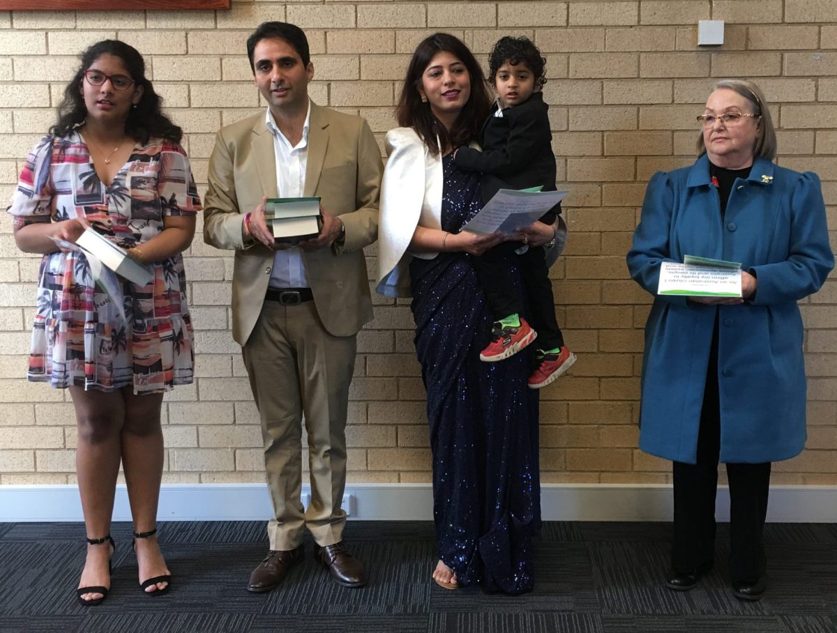 three adults and two children with their citizenship certificates