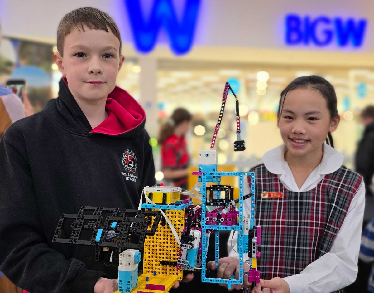 two primary school students with their robotics creation