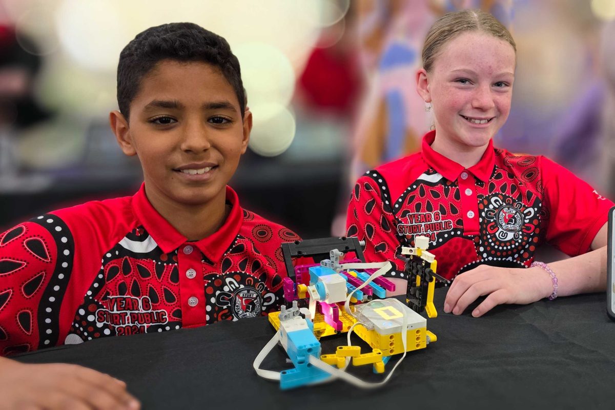 Two primary school students with their robotics project