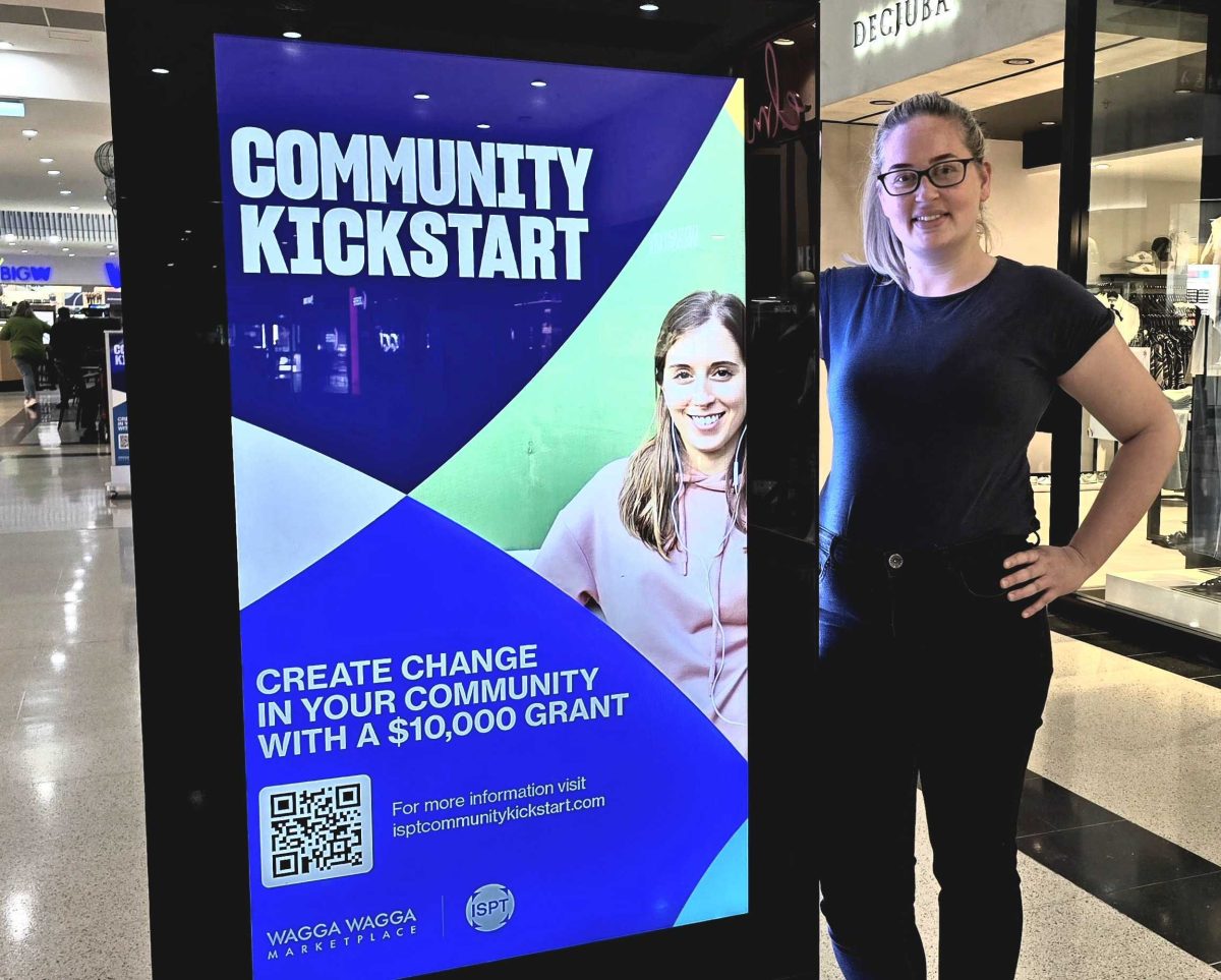 woman standing next to poster in shopping centre