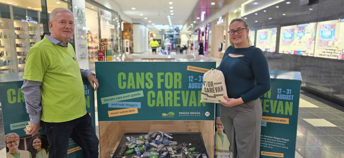 a man and a woman at a donation site in a shopping centre