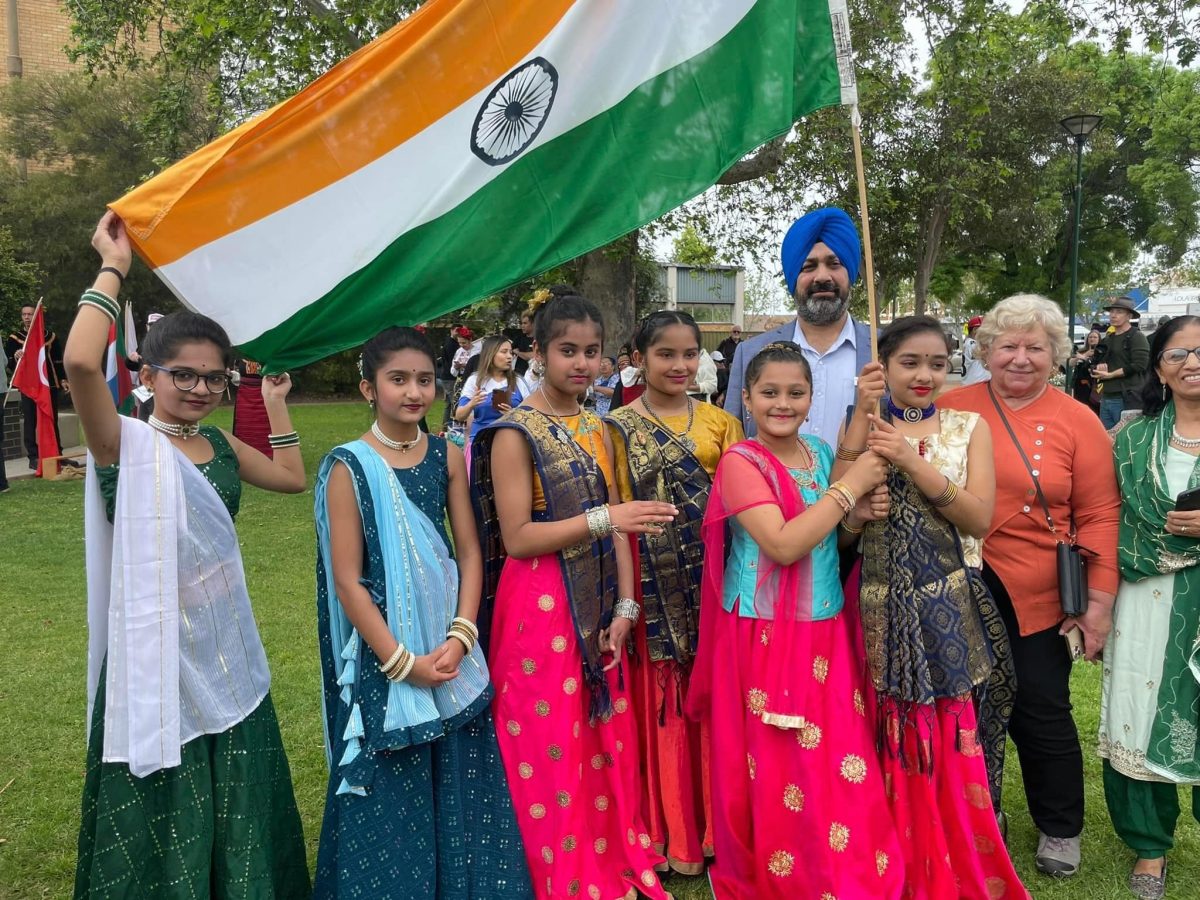 Manjit Lally with Indian flag and group 