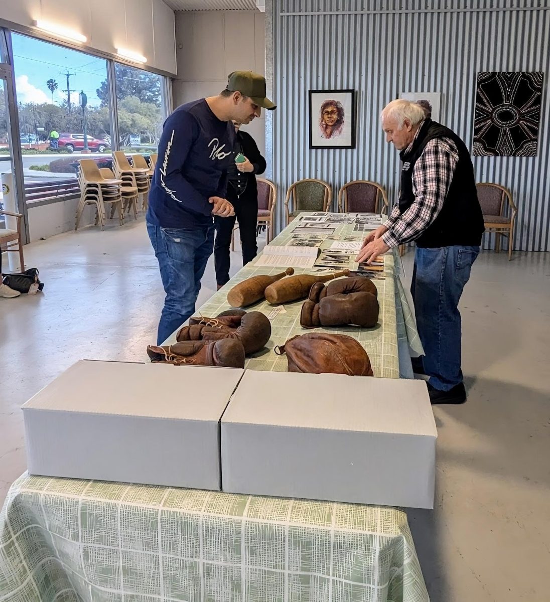 Two guys looking at museum memorabilia 