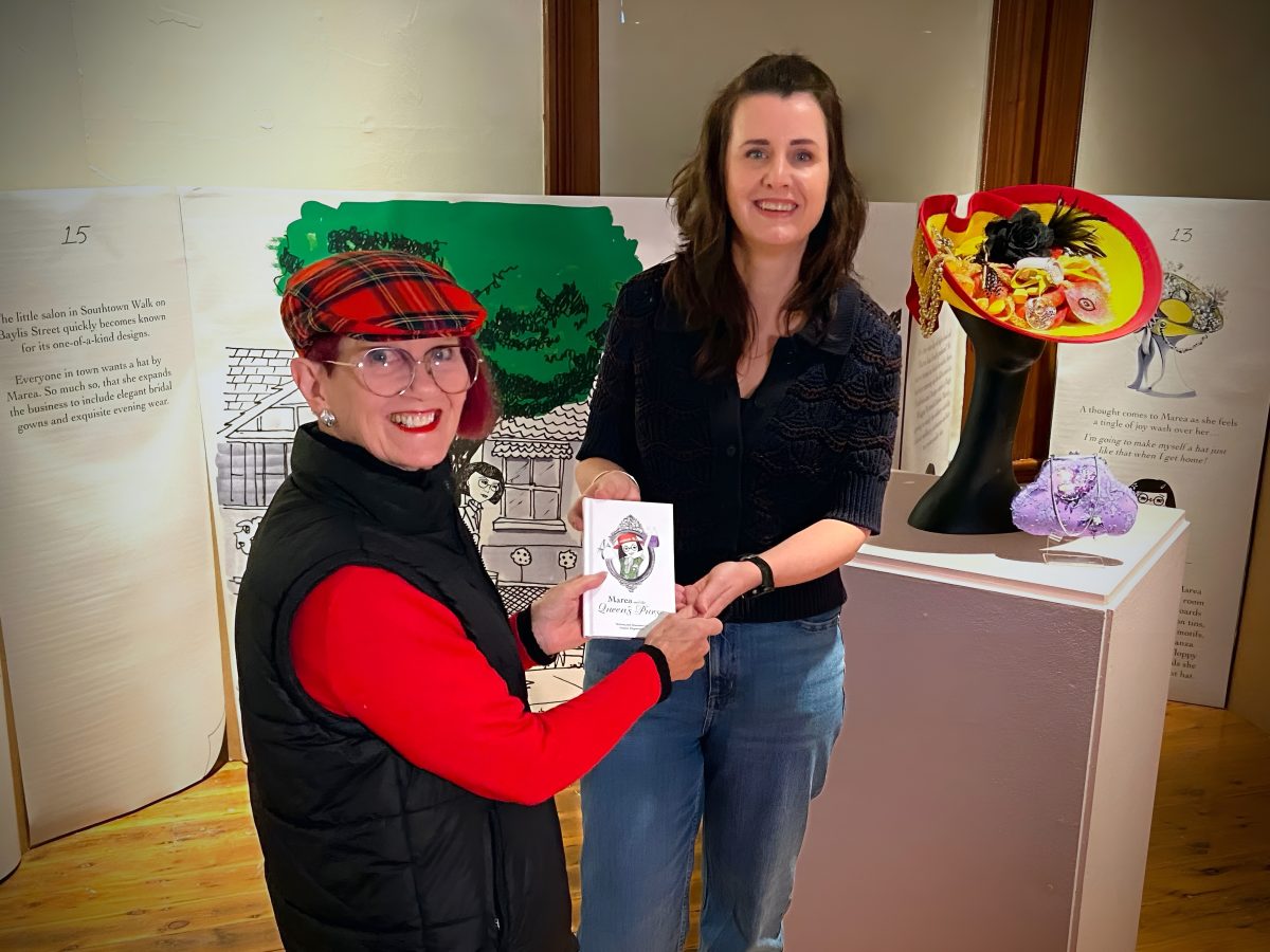 Milliner Marea Bright and curator Sophie Magnusson preparing to open the exhibition, Marea and the Queen’s Purse.