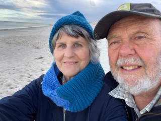 a selfie of a man and a woman on a beach