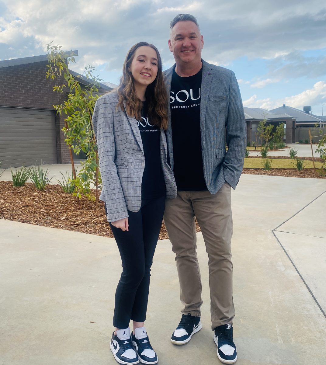 Nathan and Myah Thomas outside homes