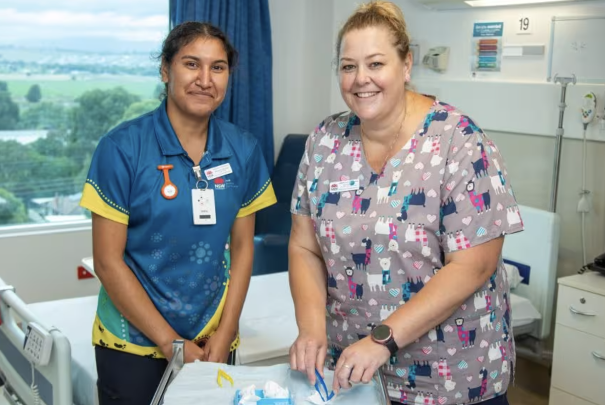 Two nurses around a desk