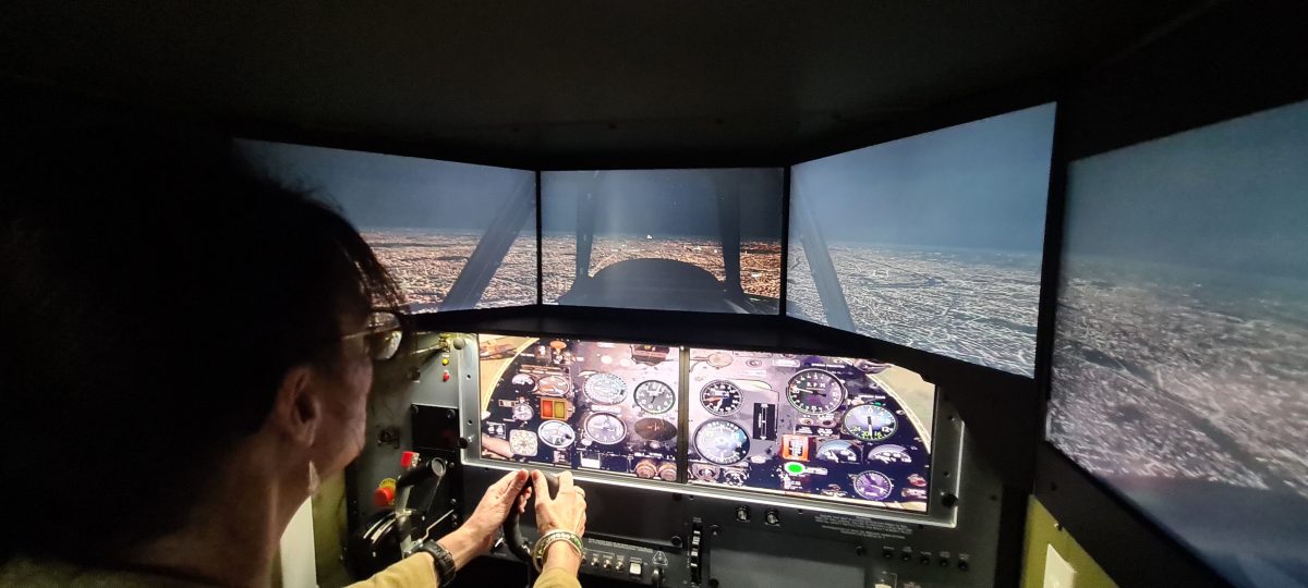 Member for Cootamundra Steph Cooke tries out the new Warbirds simulator at the Temora Aviation Museum.