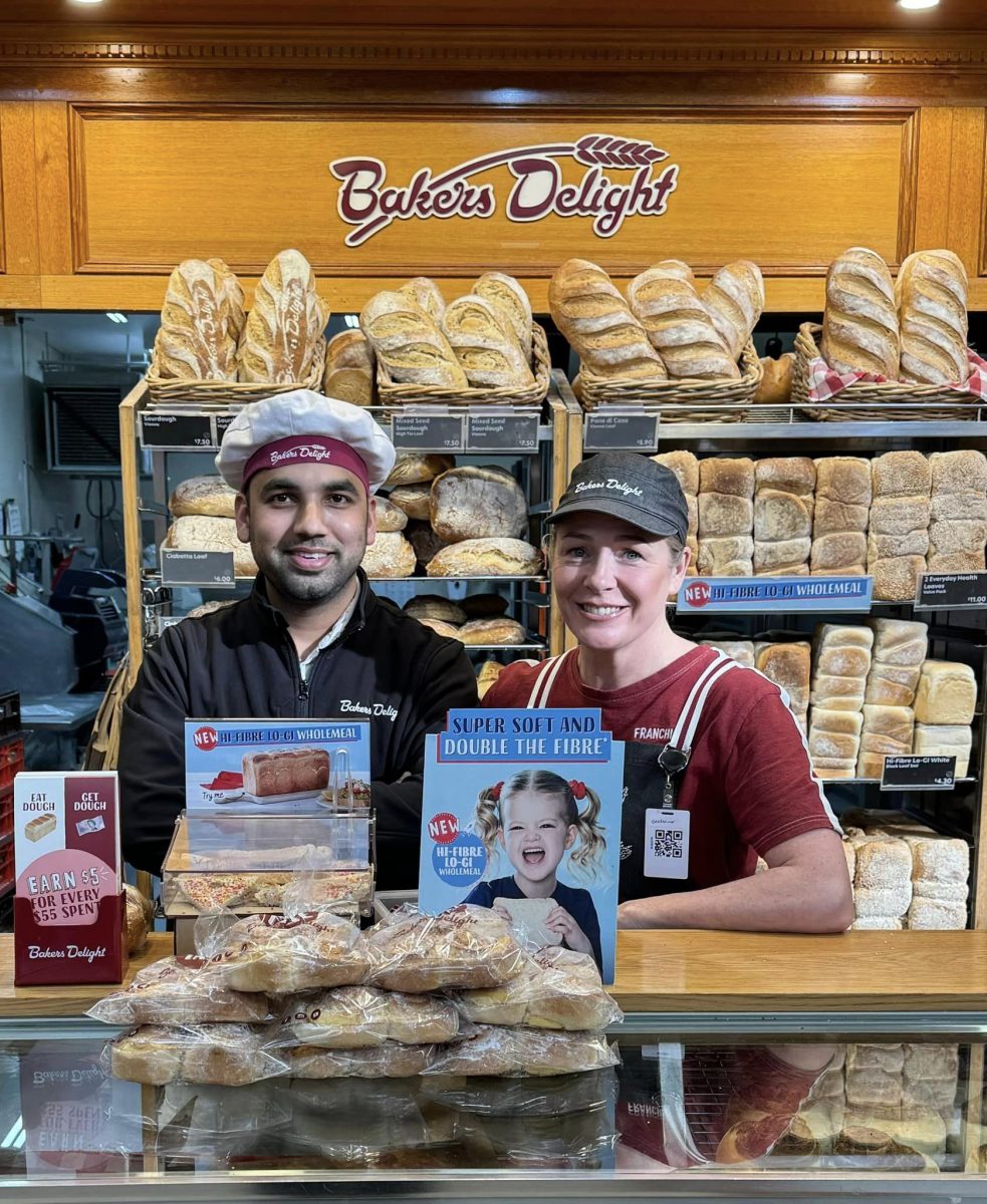 Two people in uniform at bakery 