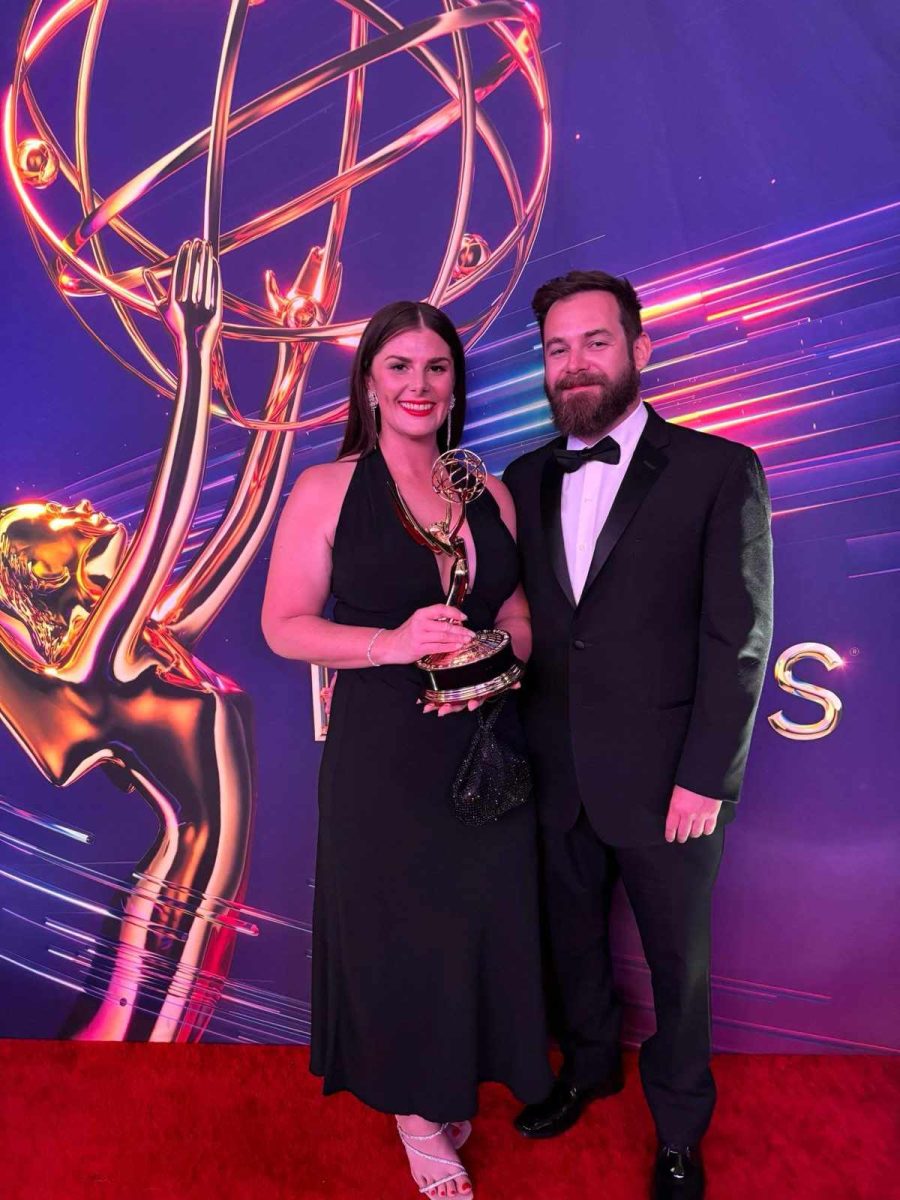 Woman with her partner and her award