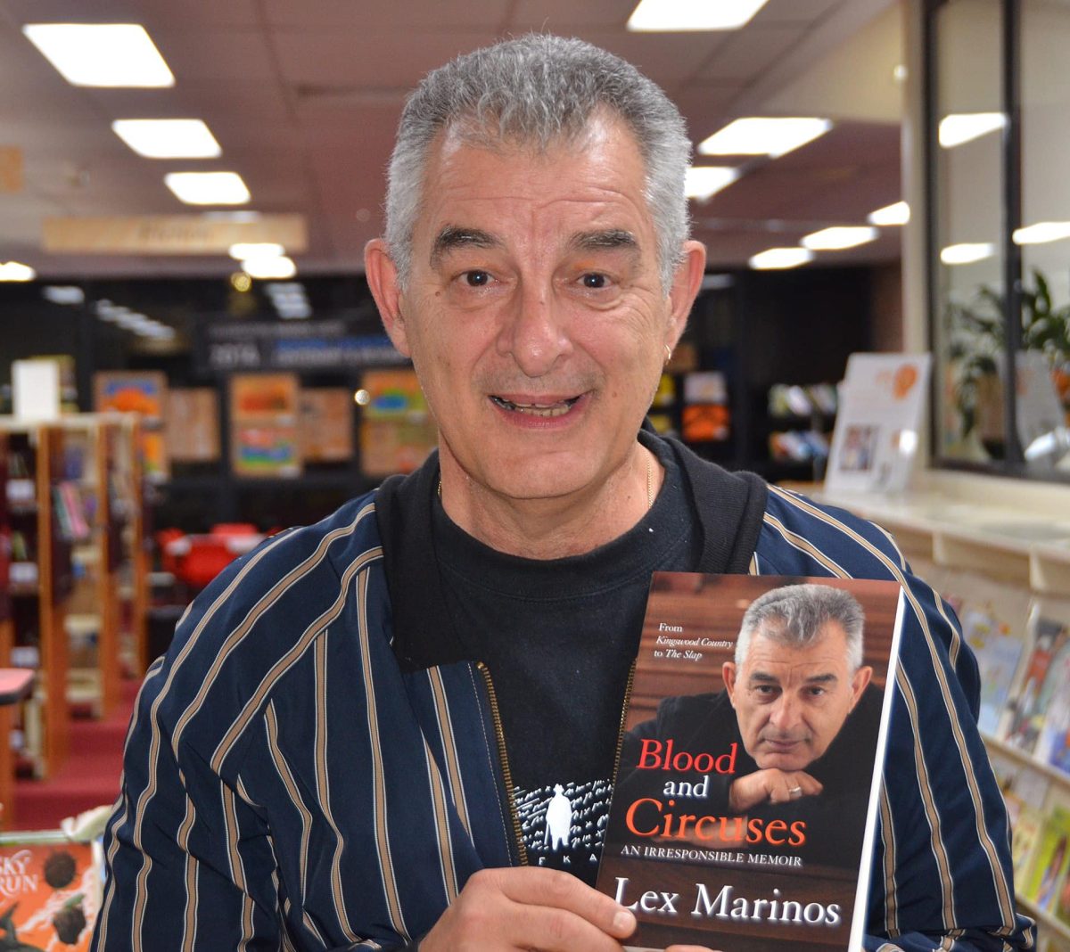 man holding his autobiography 