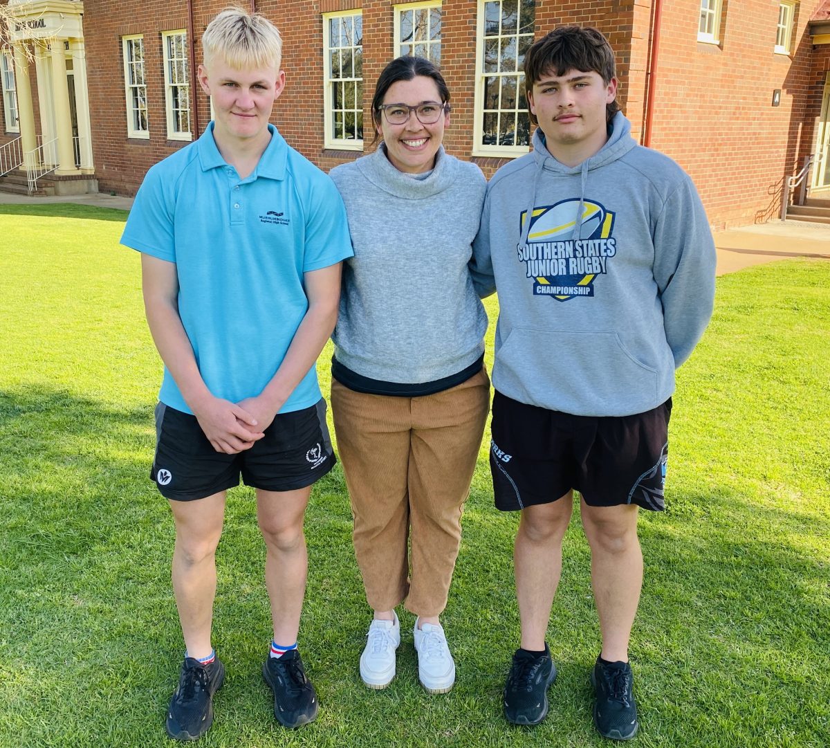 Two rugby players and mum on oval 