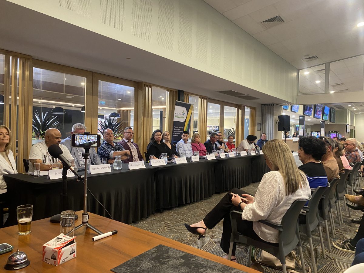 row of candidates facing the press at election forum 