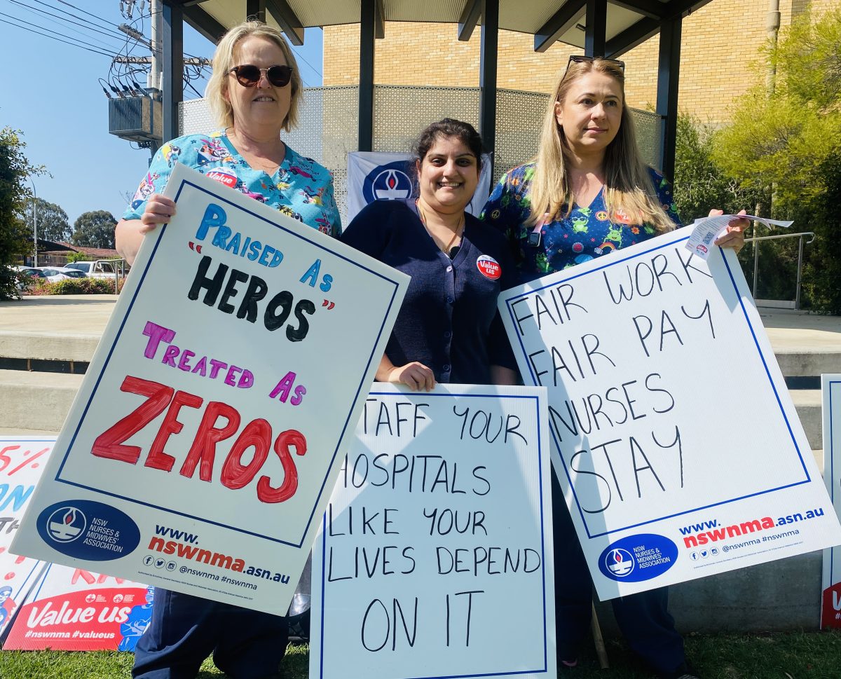 Nurses with protest signs 