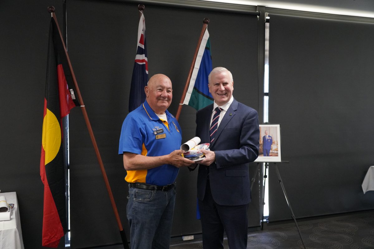 Federal Member for Riverina Michael McCormack presents the Australian National Flag and other nationhood material to Junee RSL Sub-Branch President Greg Zakharoff. 