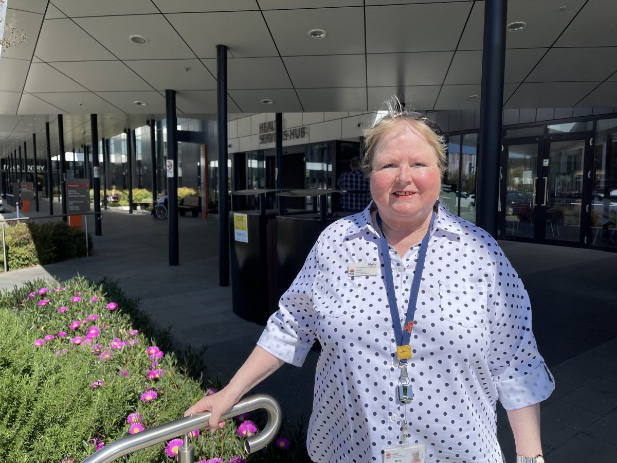 Woman standing in front of a hospital