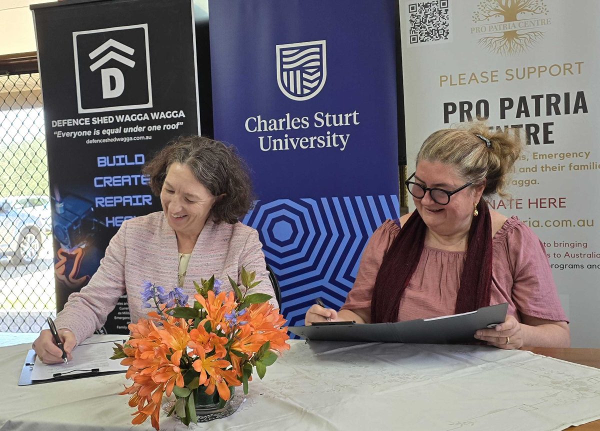 two women signing official agreement