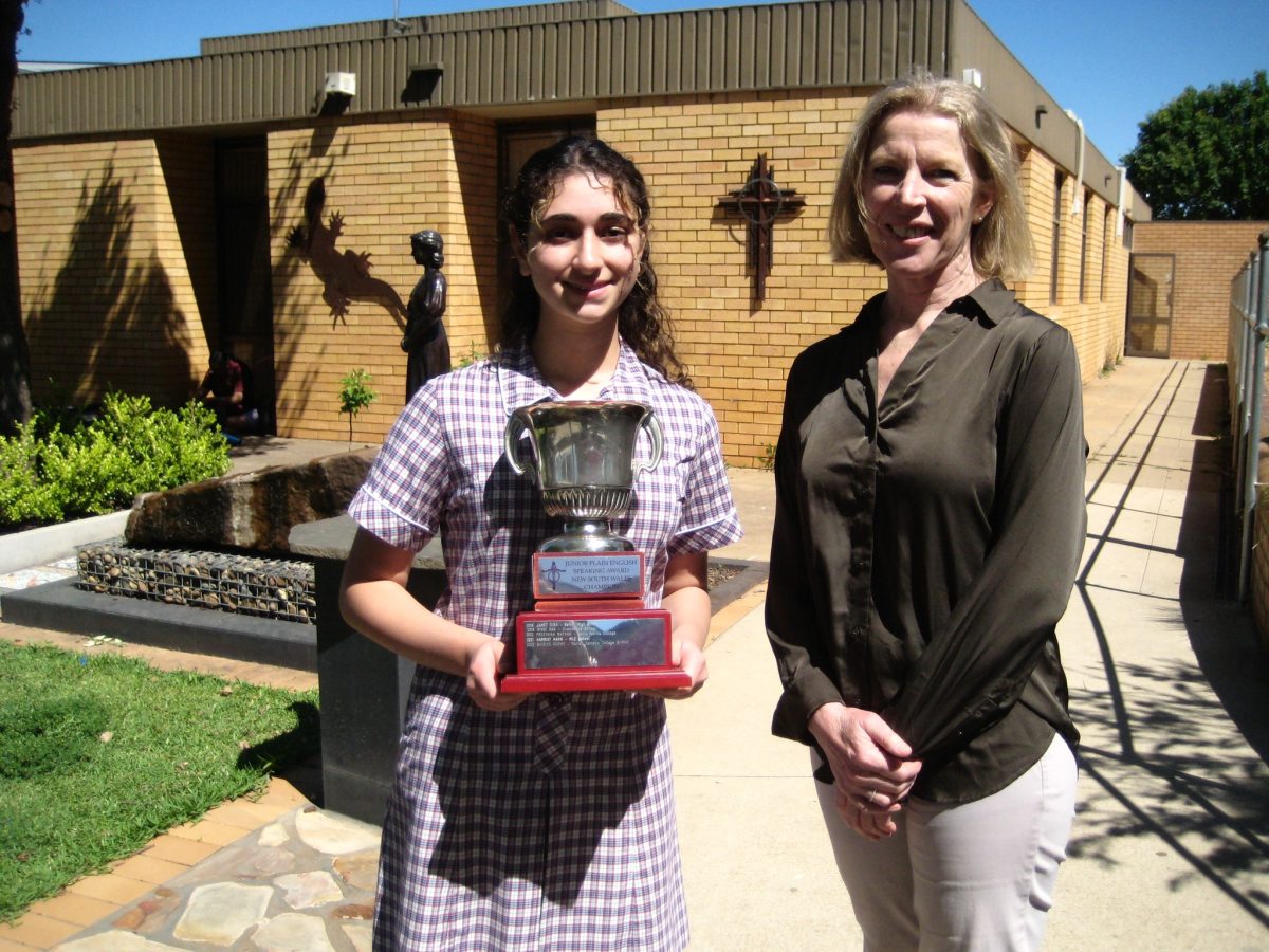 Student with trophy and principal 