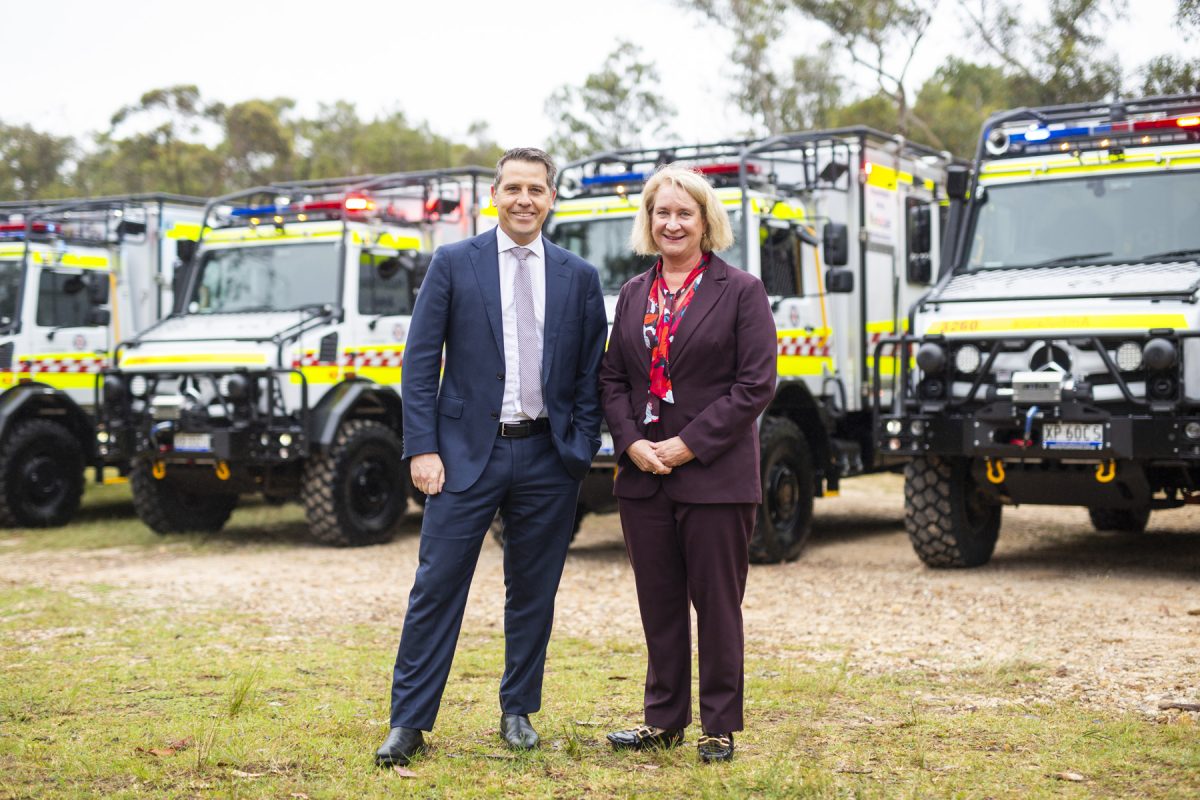 a man and a woman with Unimog ambulance vehicles