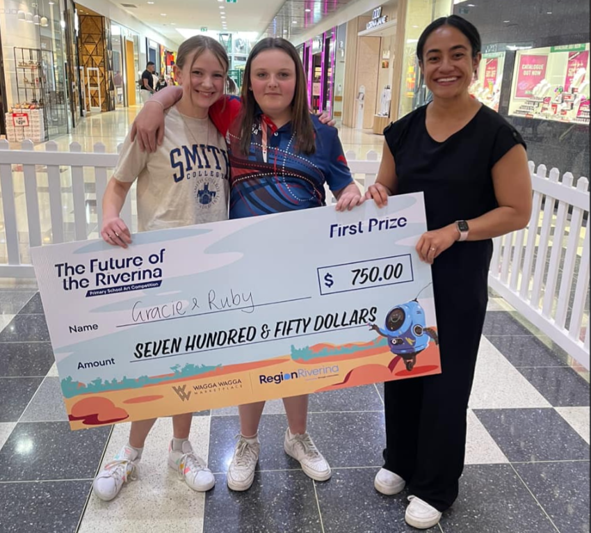 Region Riverina and Wagga Wagga Marketplace’s annual Primary School Art Competition first place winners Gracie and Ruby with Region's Shayna Siakimotu