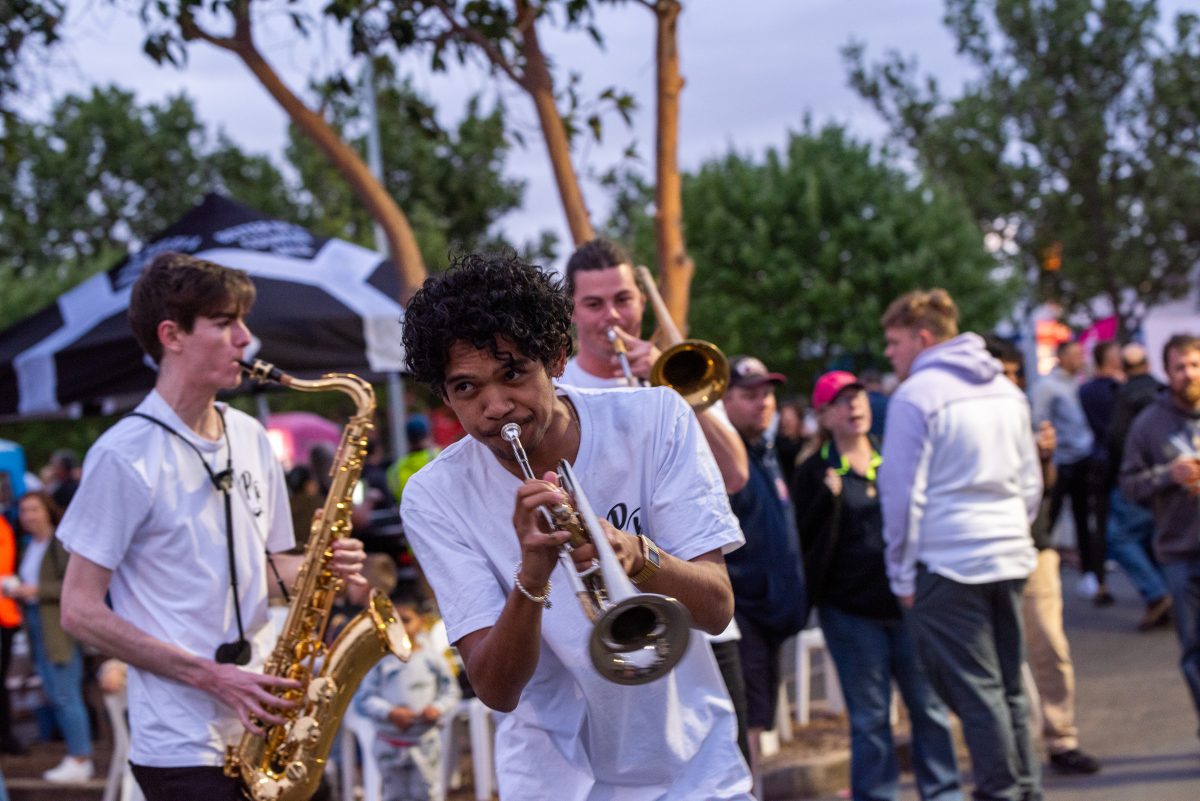 Guy playing sax at a festival