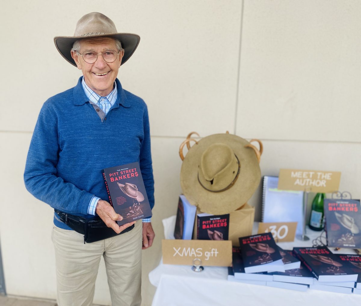 Guy in hat next to book stall 