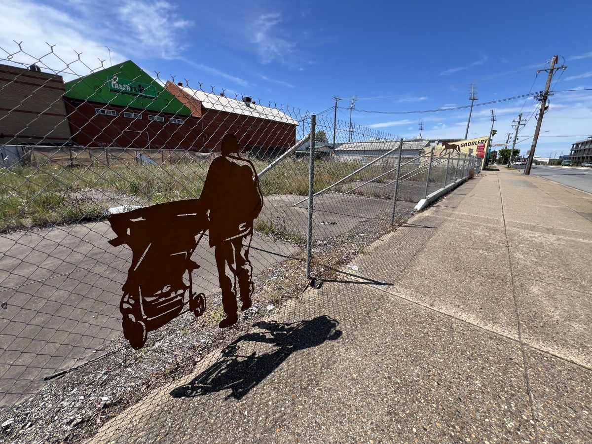 A silhouette of the late Larry Skewes pushing his pram into the wasteland.