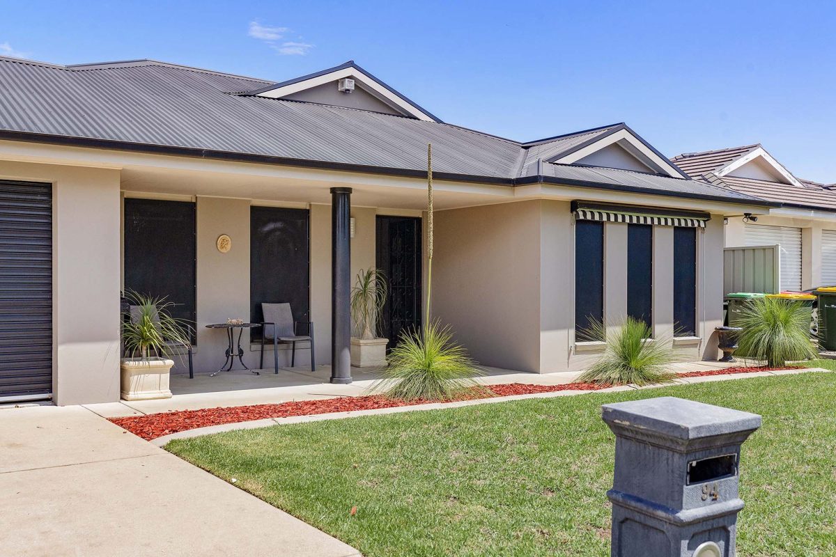 front of a lowset brick house