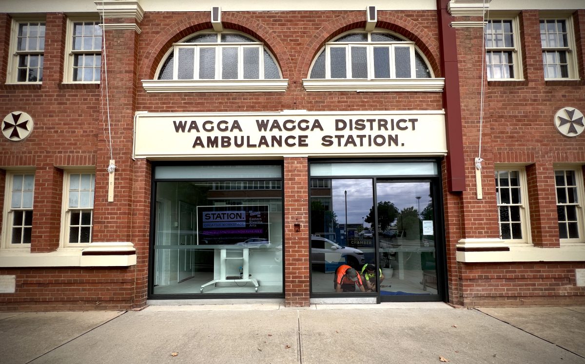 Tradesmen put the finishing touches on the Ambo Gallery's new front windows. 