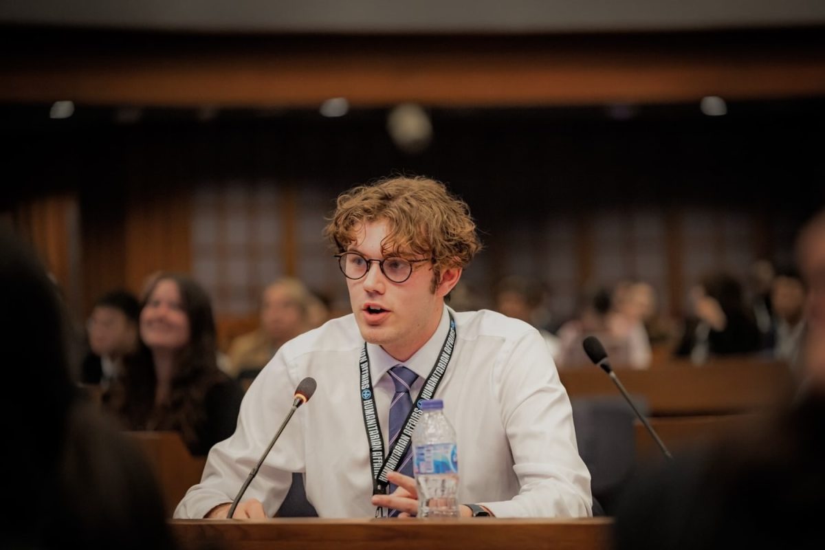 a young man speaking at a conference