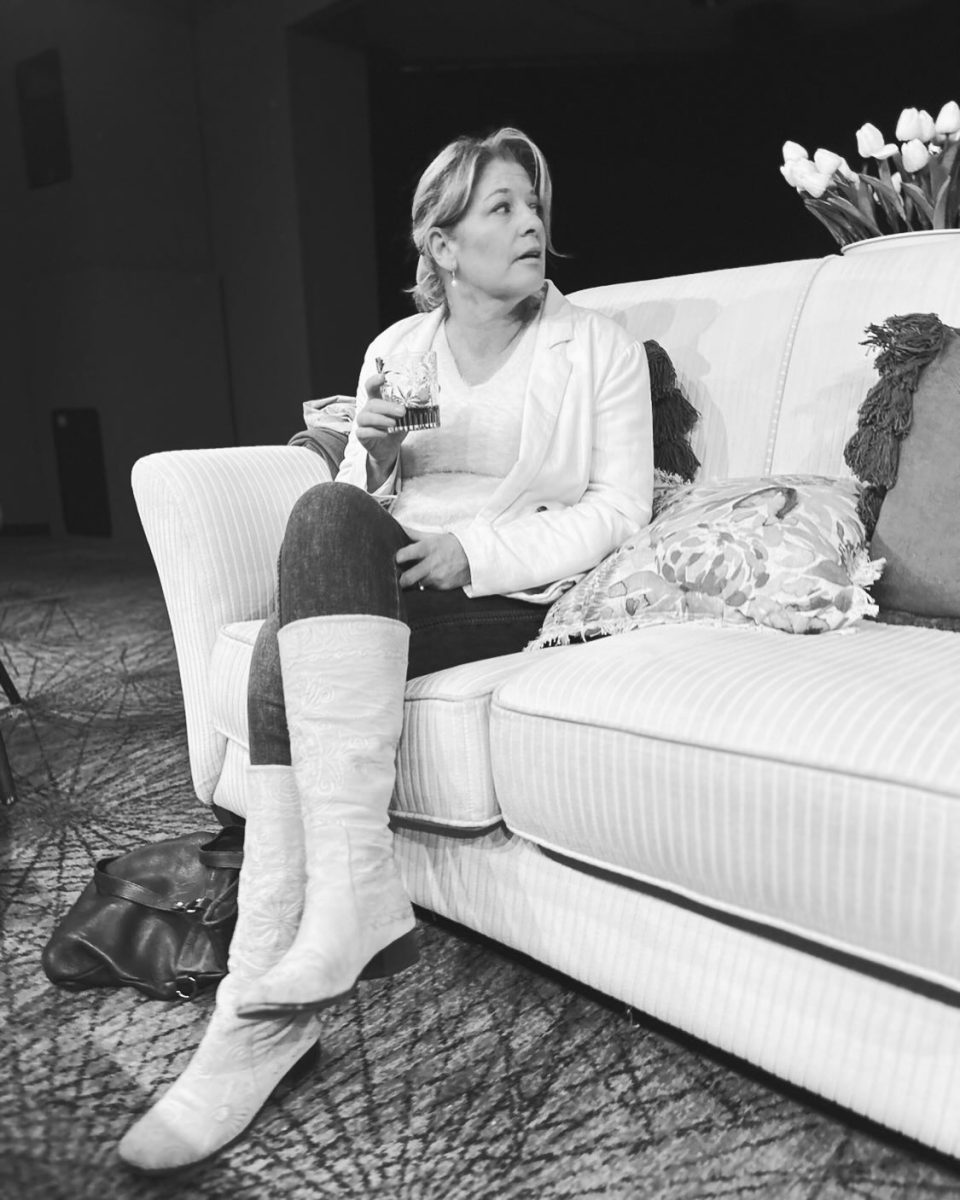 actress sitting on a couch on a set