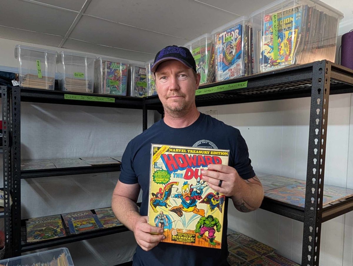 a man holding a comic book