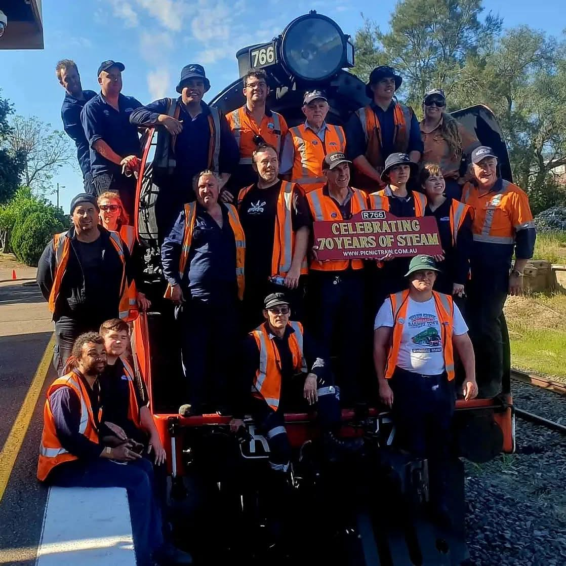 a group of people with a steam train