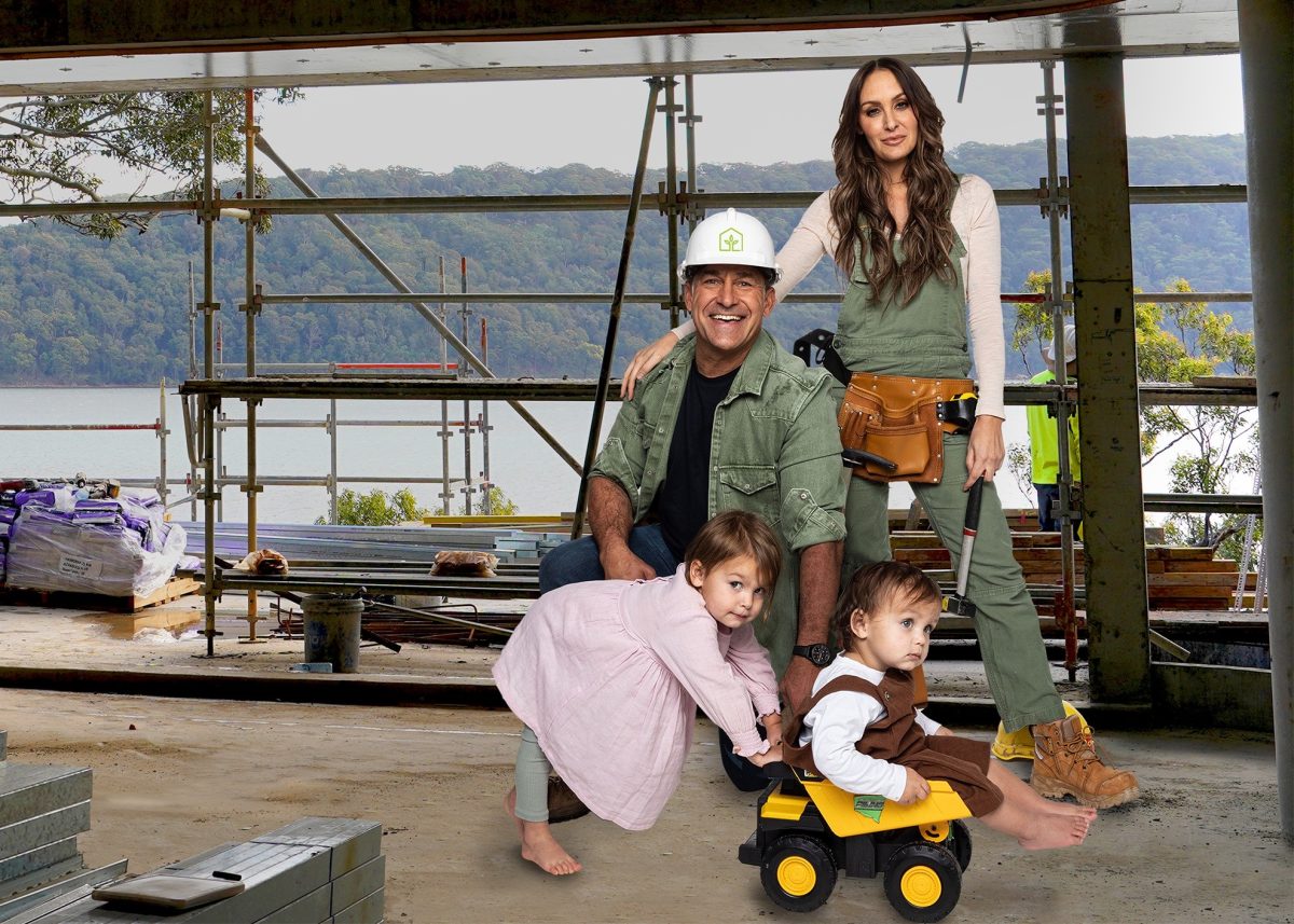 a man, a woman and two kids at a house under construction