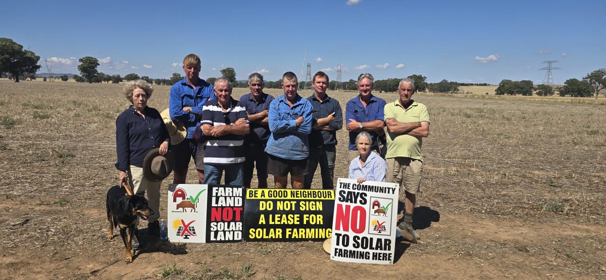 Farmers with signs protesting against solar farms