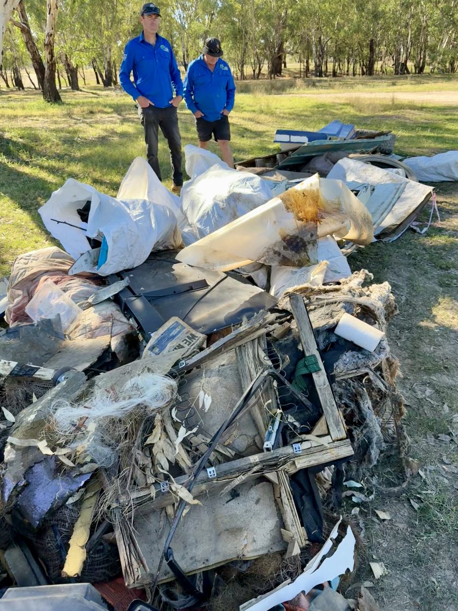 two men in a park with collected rubbish