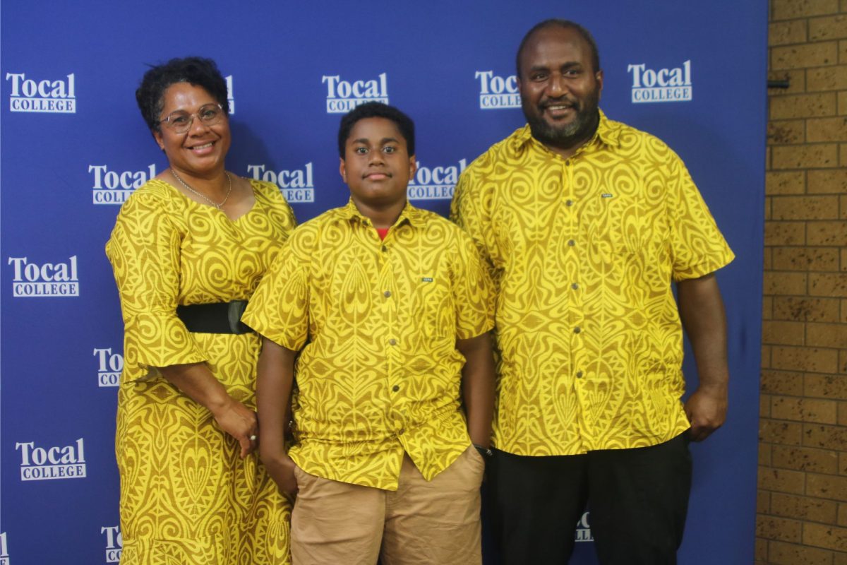 Yanco graduate and family in colourful shirts