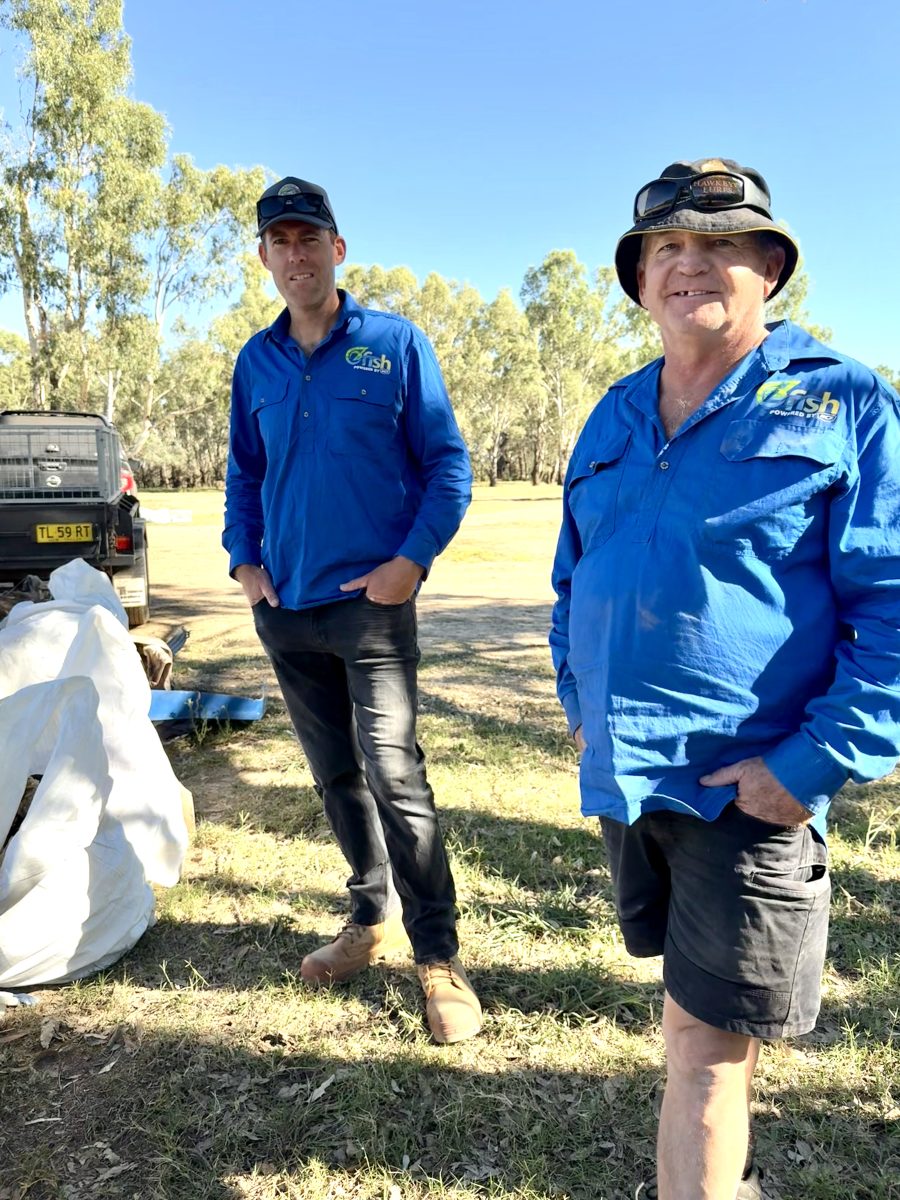 two men in a park, with a ute and collected rubbish 