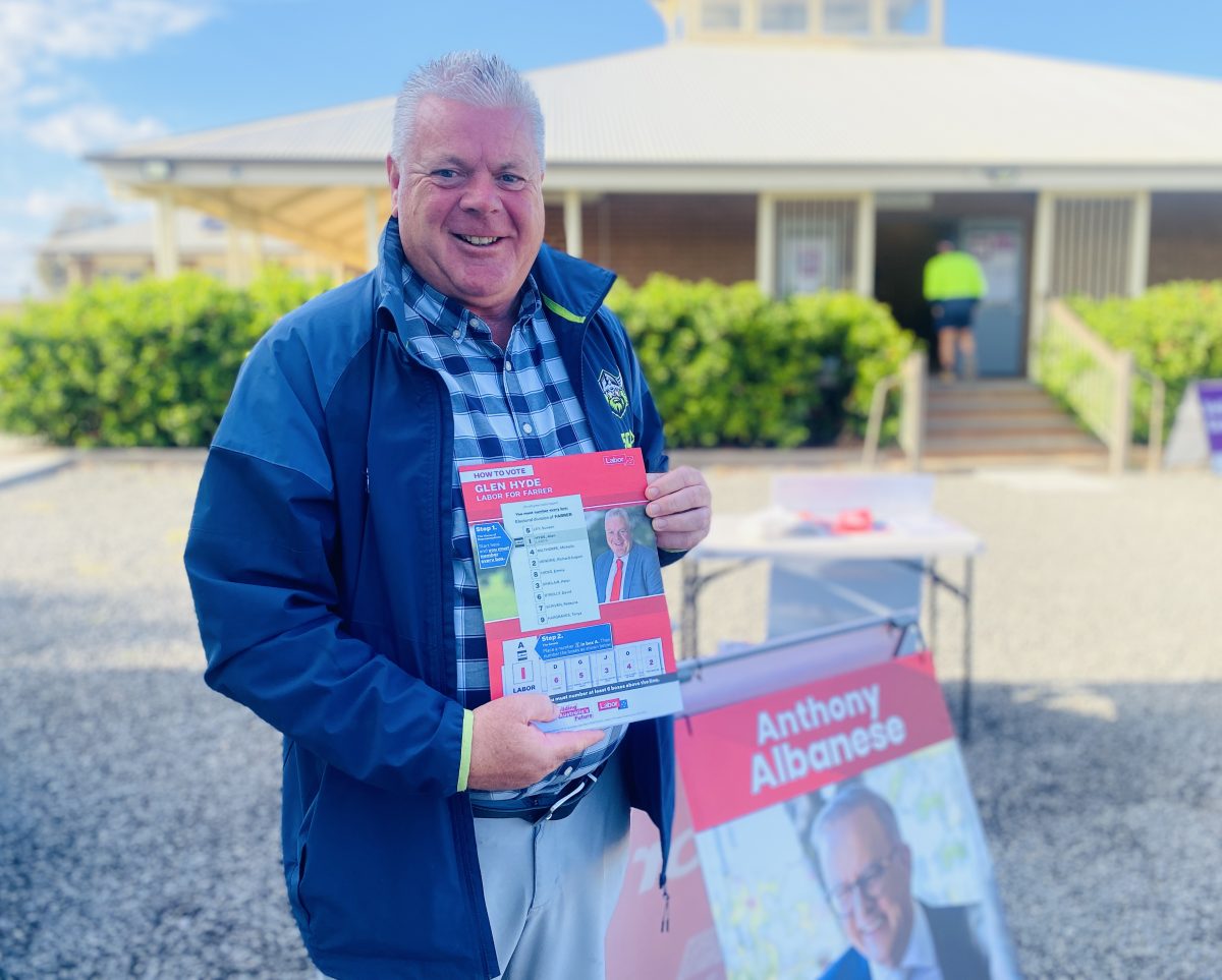 Glen Hyde with how to vote card